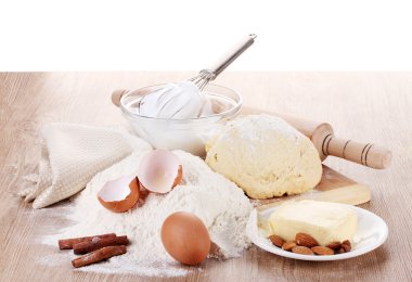 Ingredients for the dough wooden table on white background clipart