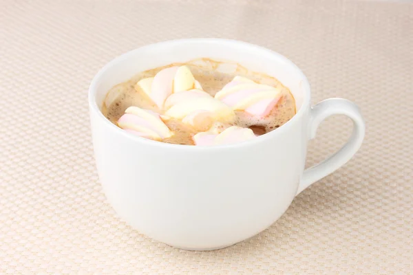 Tasse Cappucino mit Marshmallows auf beigem Hintergrund — Stockfoto