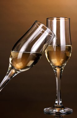 Glasses of champagne on brown background clipart