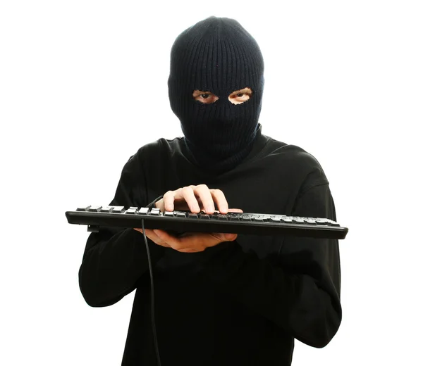Hacker en máscara negra con teclado aislado en blanco — Foto de Stock