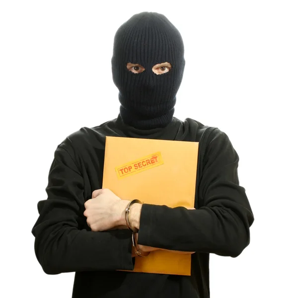 Bandit i svart mask i handbojor med topp hemliga kuvert isolerad på vit — Stockfoto