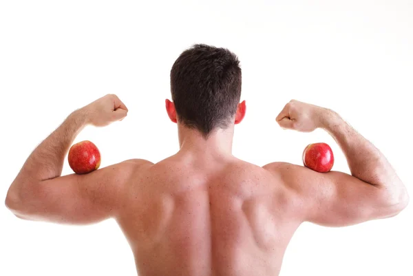 Athletic sexy male body builder holding red apple — Stock Photo, Image