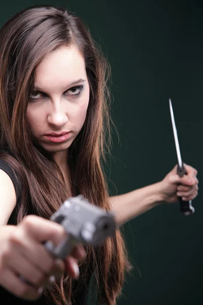 Sexy young woman long hair - gun knife — Stock Photo, Image