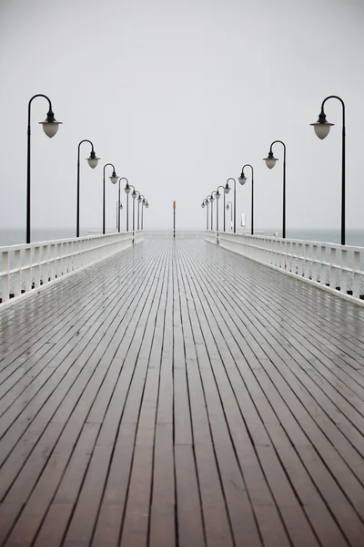 Old pier in rain on Baltic sea Orlowo Gdynia Poland — Stock Photo, Image