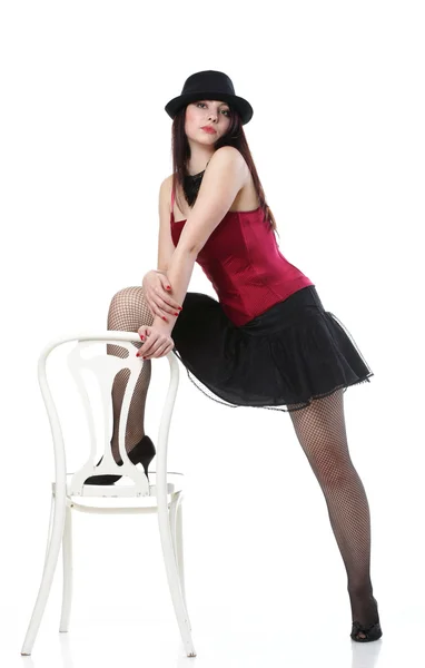 Tanec tanečnice žena v křesle červený korzet bílý izolované — Stock fotografie