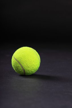 Tennis balls on black background studio shot clipart