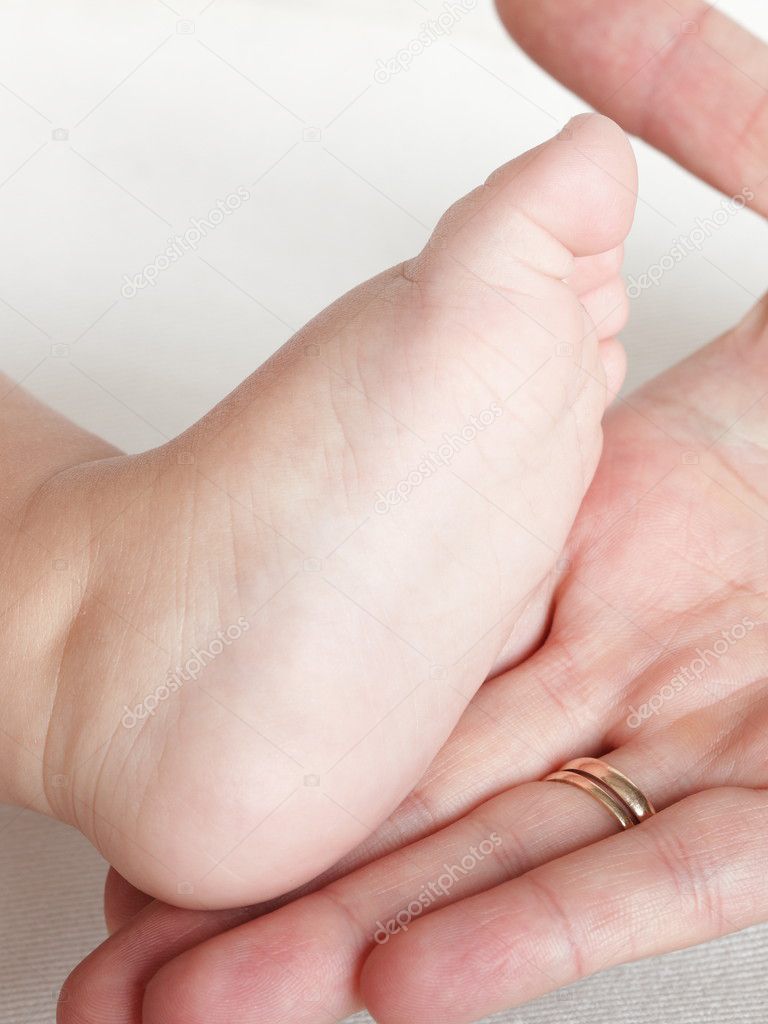 Baby Foot In Mother's Careful Hands Stock Photo, Picture and Royalty Free  Image. Image 34998832.