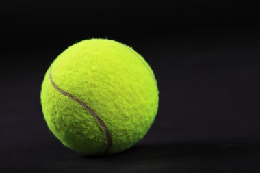 Tennis balls on black background studio shot clipart