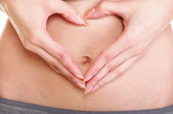 stock image Sexy young woman heart shape hands belly