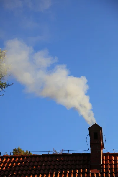 stock image Smoke from a chimney sky blue