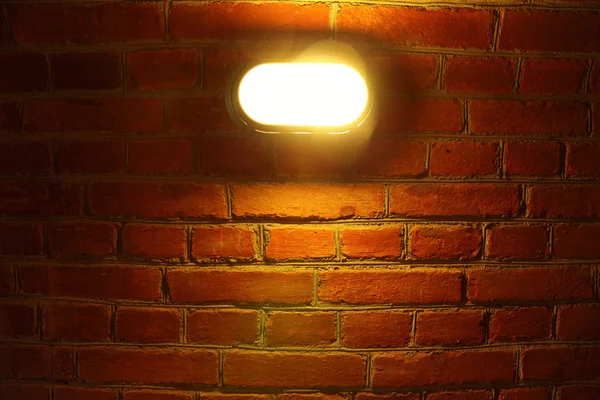 Stock image Old red brick wall with street light