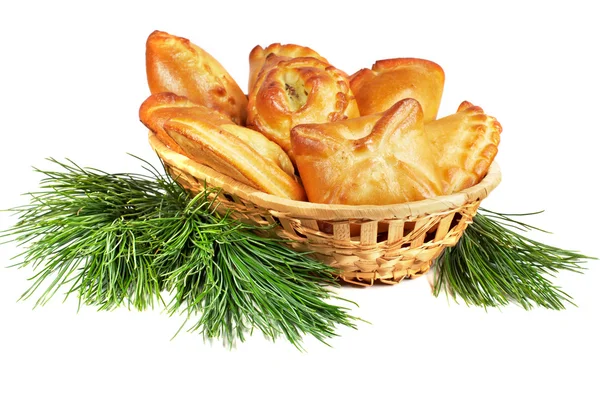 Set of pies in a basket with pine boughs — Stock Photo, Image