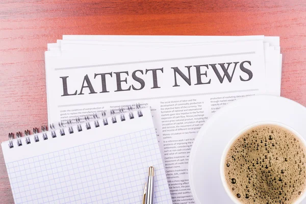 The newspaper LATEST NEWS on table and coffee — Stock Photo, Image
