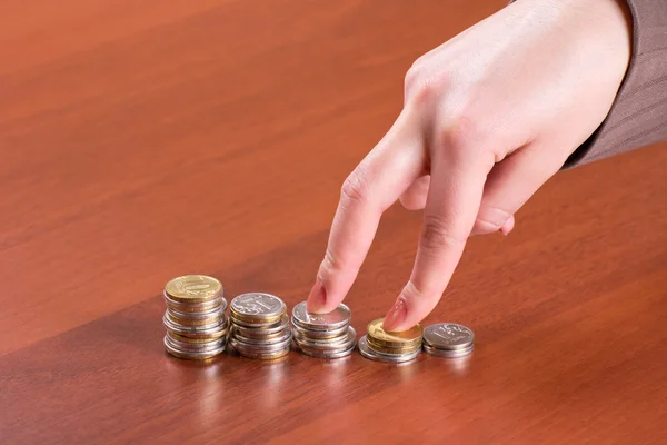 Stacks of coins and hand — Stock Photo, Image