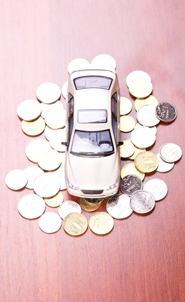 Model car on a placer of coins — Stock Photo, Image