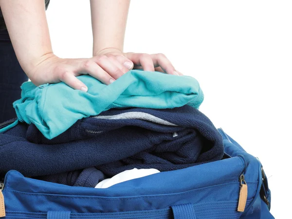 Woman hand crammed full of clothes and shoulder bag isolated — Stock Photo, Image