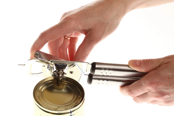 Hand and can with can opener — Stock Photo, Image