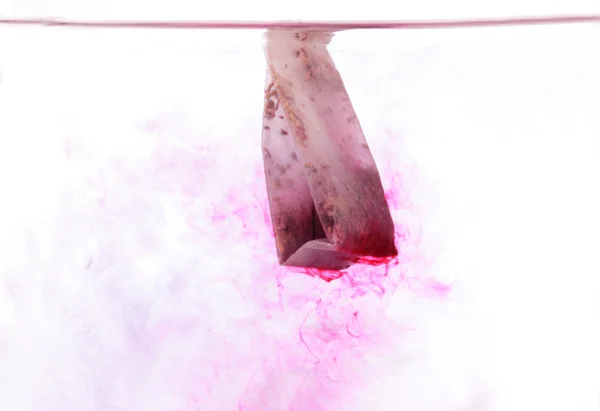Red Teabag in hot water — Stock Photo, Image
