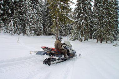 Man on a snowmobile clipart