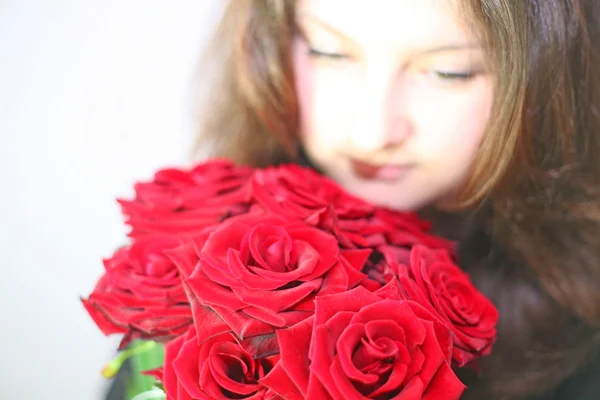 那个女孩看着一束玫瑰花 — 图库照片