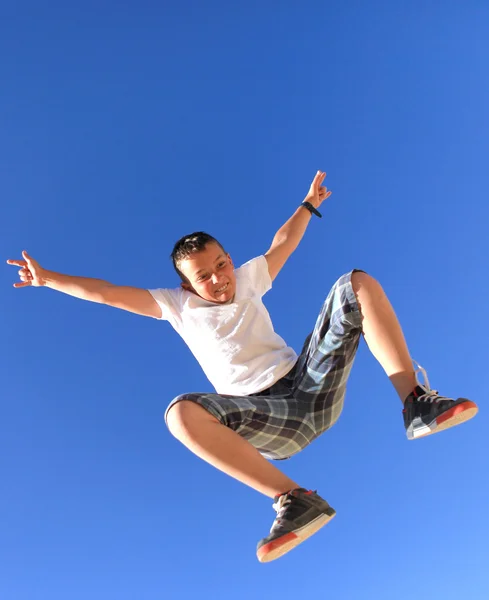 Flying bouncing boy with sky — Stock Photo, Image
