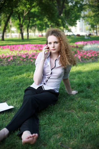 Redhead curly girl with the phone talking — Stock Photo, Image
