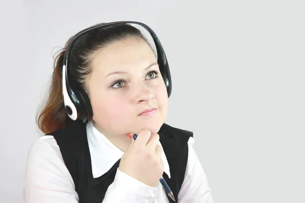 Young girl manager on the headphones — Stock Photo, Image