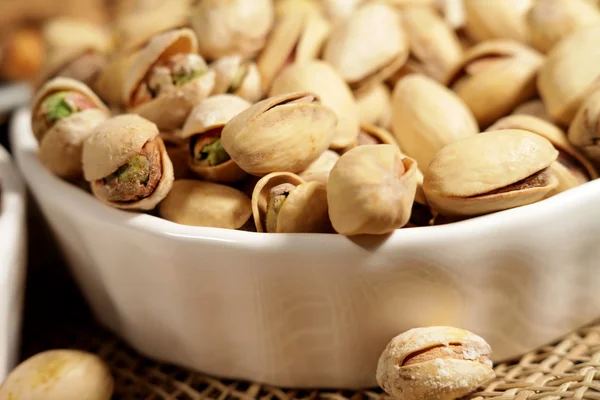 Pistachios in a white saucer