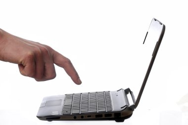 Man's Hand Hovering Over Netbook. clipart