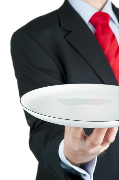 Geschäftsmann hält leeren Teller isoliert auf weiß — Stockfoto