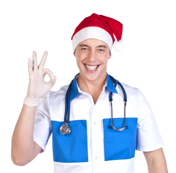 Ung sjukvårdare i röd jul hatt — Stockfoto