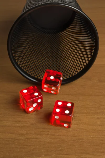 Red dice near a container — Stock Photo, Image