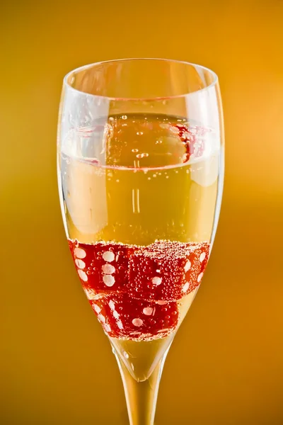 Red dice in a champagne flute — Stock Photo, Image