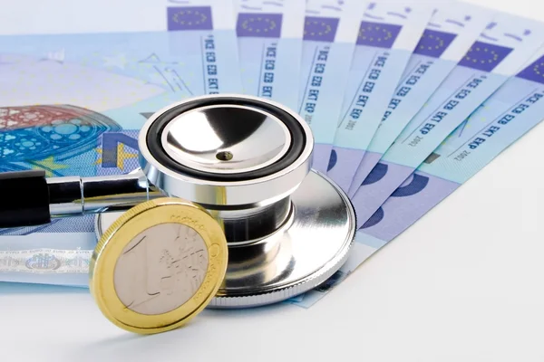 Stethoscope on banknote near euro coin — Stock Photo, Image