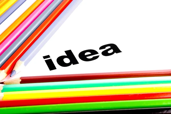 Many colored pencils near the word idea — Stock Photo, Image