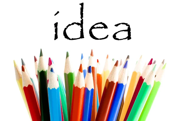 Colored pencils under the word idea — Stock Photo, Image