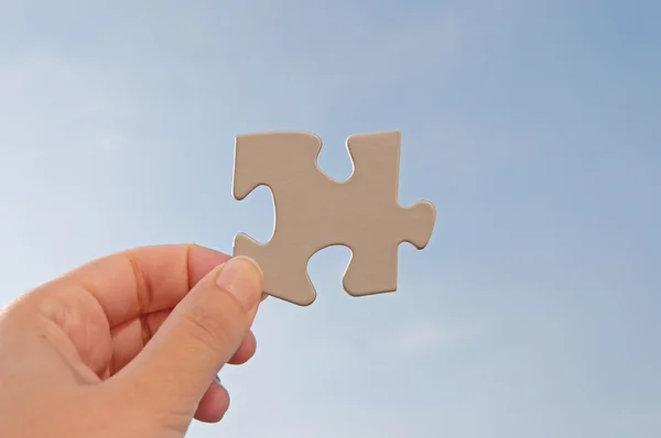 Jigsaw piece against sky — Stock Photo, Image