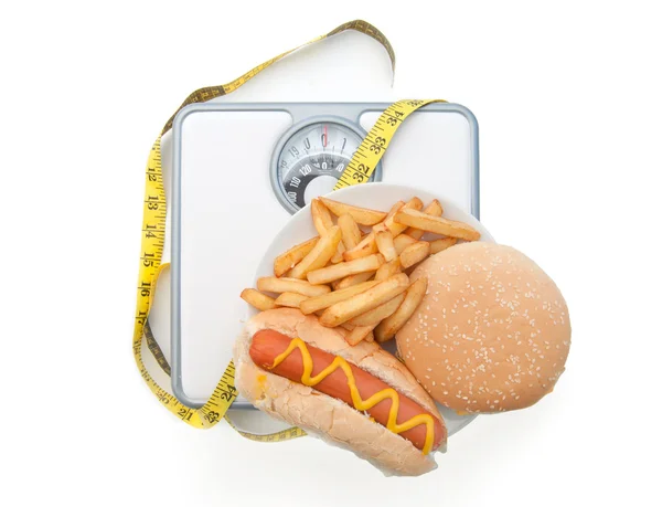 Balanzas de pesaje mala dieta —  Fotos de Stock