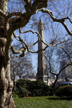 View of Cleopatra's Needle from Embankment Gardens in London clipart