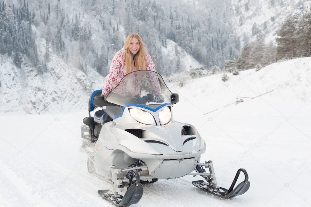 Woman driving a snowmobile