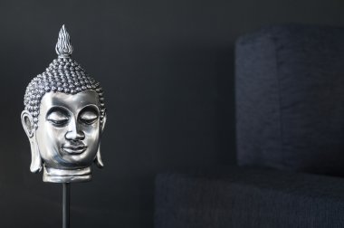 Contemporary interior design detail with buddha image and sofa clipart