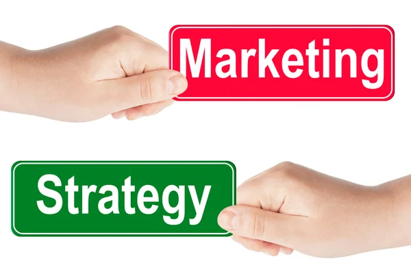 Señales de tráfico de estrategia y marketing en la mano — Foto de Stock