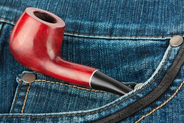 Smoking pipe in jeans — Stock Photo, Image