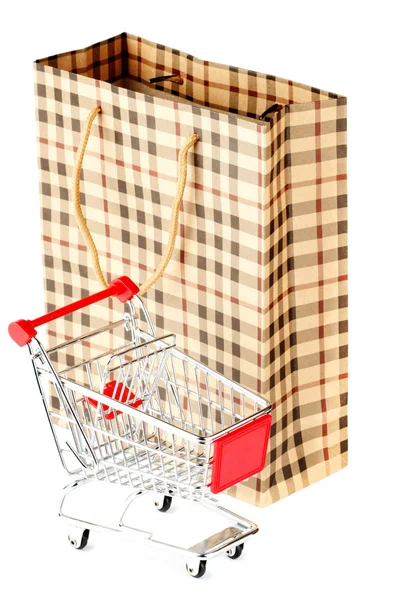 Shopping cart and paper bag — Stock Photo, Image
