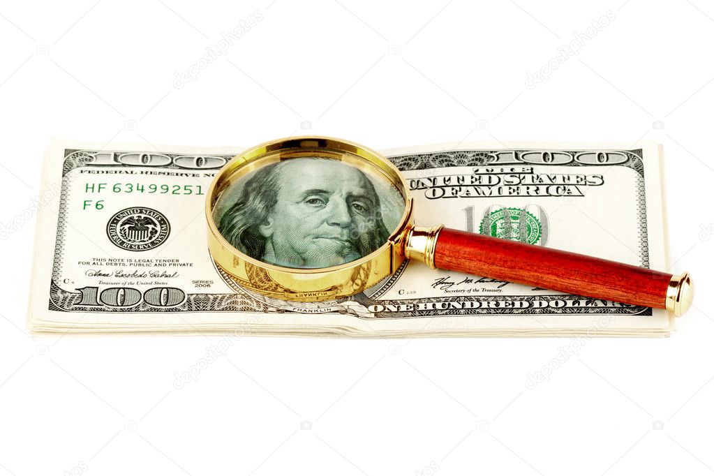 Hundred dollar bill under a magnifying glass