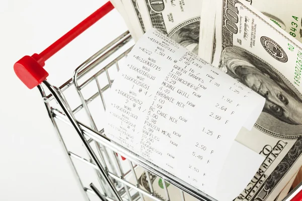 Receipt and cash in shopping cart — Stock Photo, Image