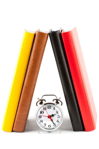 Alarm clock and colourful books — Stock Photo, Image
