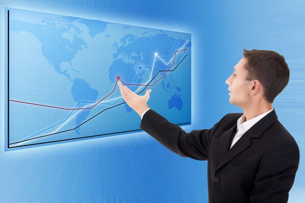 Businessman and a modern blue map with charts and graphs — Stock Photo, Image