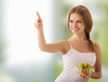 Beautiful young woman with a salad choose healthy food clipart