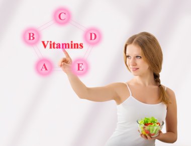 Beautiful girl with salad choose foods rich in vitamins clipart